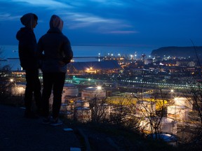 Oil storage tanks stand illuminated at night at the RN-Tuapsinsky refinery, operated by Rosneft Oil Co., in Tuapse, Russia.