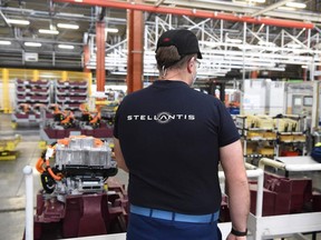 An employee works on an electric engine assembly line at automaker Stellantis plant in Tremery, eastern France.