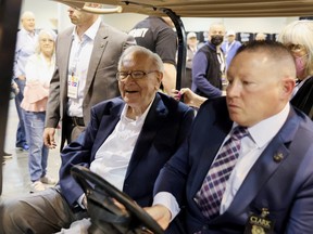 Berkshire Hathaway CEO Warren Buffett rides on a golf cart through the exhibition hall as investors and guests arrive for the first in-person annual meeting since 2019 of Berkshire Hathaway Inc in Omaha, Nebraska, U.S. on Saturday.