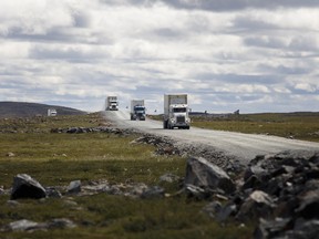 Trucks drive along a road between Baker Lake and the Agnico Eagle Mines Ltd. Meadowbank site in Meadowbank, Nunavut.