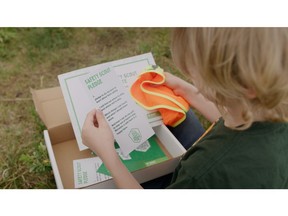A child opens their BASF Safety Scout kit including the vest.