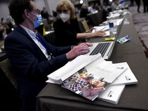 Copies of the 2022 federal budget are seen on a table as journalists work in the media lockup in Ottawa.