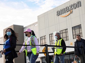 Workers stand in line to cast ballots for a union election at Amazon's JFK8 distribution center in the Staten Island borough of New York City.