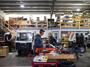 A worker assembles an electric conversion of a concrete transport inside the Canadian Electric Vehicles Ltd. manufacturing facility in Parksville, B.C.