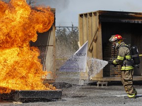 Emmons demonstrates how quickly the company's new gel additive, Eco-Gel, can put out a heptane fire and not re-ignite during a demonstration at the Loyalist Township Emergency Services Fire Training Centre in Odessa, Ont.