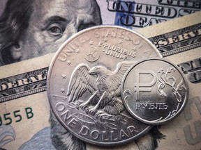 A Russian ruble coin with U.S. dollar bills and a one dollar coin.