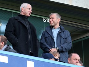 Director of Chelsea Eugene Tenenbaum standing alongside owner Roman Abramovich.