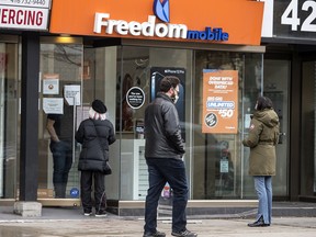 Patrons shop at a Freedom Mobile location on Toronto’s Queen Street West.