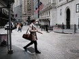 People walk by the New York Stock Exchange on April 25, 2022 in New York City.