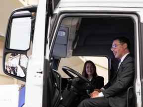 Doug Schweitzer, Alberta’s Minister of Jobs, Economy and Innovation, checks out a Nikola truck at the company’s booth at the Canadian Hydrogen Convention at Edmonton Convention Centre on April 26, 2022.