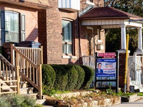 A for sale sign is displayed outside a home in Toronto, Ontario in Toronto, Ontario, Canada December 13, 2021.