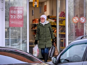 A woman leaves a grocery store in Russia.