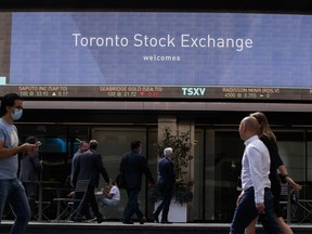 Pedestrians pass in front of the Toronto Stock Exchange in the financial district of Toronto, Ontario, Canada, on Thursday, Sept 16, 2021.