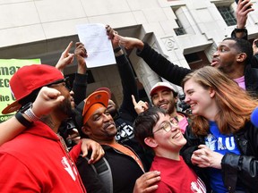 Union organizer Christian Smalls, left, celebrates with Amazon workers following the April 1, 2022, vote for the unionization of the Amazon Staten Island warehouse in New York.