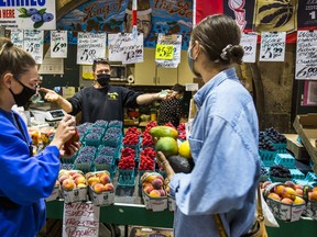 Customers shop at St. Lawrence Market in Toronto.
