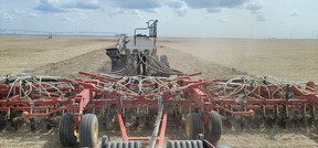 A farmer plants durum wheat in a field on his farm by Barons, Alta.