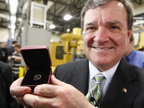 Late finance minister Jim Flaherty with the last pressed penny in 2012.
