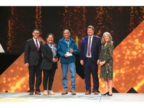 From left, William Liu, Regulatory Specialist with De Beers Group, joins Ni Hadi Xa (NHX) representatives Rosy Bjornson (NHX Environmental Manager) and Tom Unka (NHX Governance Committee Chair) to receive the 2022 TSM Community Engagement Excellence Award on behalf of Gahcho Kué Mine. The award was presented at the Canadian Institute of Mining, Metallurgy and Petroleum's 2022 convention in Vancouver, B.C.