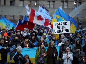 People attend a candlelight vigil for Ukraine at Nathan Phillips Square in Toronto on April 23, 2022.