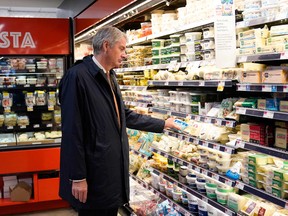 Emmanuel Besnier, chief executive officer of French family-owned dairy products group Lactalis, looks at products at a Whole Foods after touring the Stonyfield Farm plant in Londonderry, New Hampshire on May 4, 2022.
