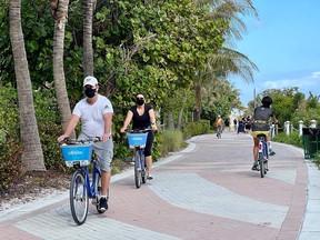 Bicycle tourists on the beach in Miami, Florida.