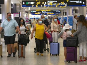 Travelers walking through Concourse D at Miami International Airport in Florida.