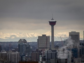 The Rocky Mountains behind the skyline in Calgary, Alta.