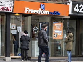 Patrons shop at a Freedom Mobile location on Toronto’s Queen Street West.