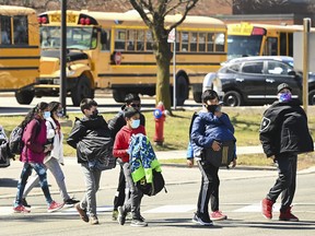 Students cross the street at Tomken Road Middle School in Mississauga, Ont.