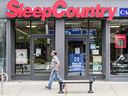 A man walks past a Sleep Country store on Queen Street East in Toronto's Beaches area.