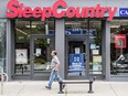 A man walks past a Sleep Country store on Queen Street East in Toronto’s Beaches area.
