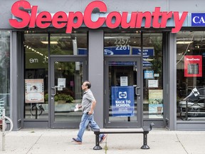 A man walks past a Sleep Country store on Queen Street East in Toronto’s Beaches area.