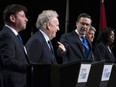 Conservative leadership candidate Pierre Poilievre gestures towards Jean Charest as Roman Baber, left, Scott Aitchison and Leslyn Lewis, right, debate at the Canada Strong and Free Network conference in Ottawa on May 5, 2022.