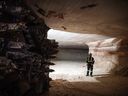 A miner stands near the cutting head of a digger near an active mining wall at the Nutrien Ltd. Cory potash mine in Saskatoon.
