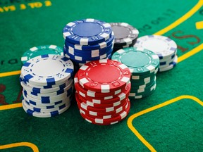 Poker chips on a green playing table.
