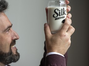 Pierre Morin, vice-president of Research and Innovation for Danone Canada, shows the new plant-based Silk Next Milk.