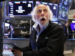 A trader works on the trading floor at the New York Stock Exchange on Thursday as investor sentiment cratered in the face of concerns that the Federal Reserve's interest rate hike the previous day would not be enough to tame surging inflation.