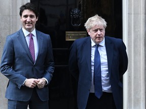 Prime Minister Justin Trudeau stands next to British Prime Minister Boris Johnson in London, in March.