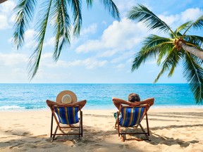 A couple relaxing on a tropical beach.