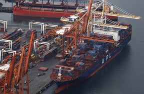 A container ship sits docked at the Port of Vancouver in November, 2021 after record rainfall and flooding halted railway access to the port.