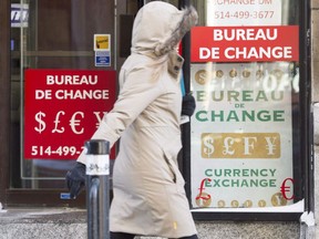 A woman walks past a currency exchange store Wednesday, January 20, 2016 in Montreal.
