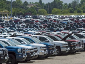 Vehicles are seen in a parking lot at the General Motors Oshawa Assembly Plant in Oshawa, Ont., on Wednesday, June 20, 2018. Statistics Canada says the country's merchandise trade surplus fell to $1.5 billion in April as both imports and exports hit record highs, helped by higher by rising prices.