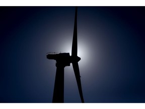 The silhouette of a GE-Alstom wind turbine is seen standing in the water off Block Island, Rhode Island, U.S., on Wednesday, Sept. 14, 2016. The installation of five 6-megawatt offshore-wind turbines at the Block Island project gives turbine supplier GE-Alstom first-mover advantage in the U.S. over its rivals Siemens and MHI-Vestas. Photographer: Eric Thayer/Bloomberg