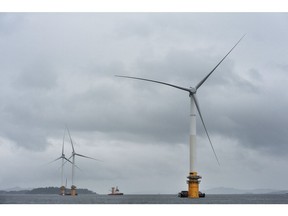 Barges position offshore floating wind turbines during assembly in the Hywind pilot park, operated by Statoil ASA, in Stord, Norway, on Friday, June 23, 2017. The world's first offshore floating wind farm will be moved to its final destination outside Peterhead, Scotland, later this summer to provide clean energy to 20,000 British households. Photographer: Carina Johansen/Bloomberg