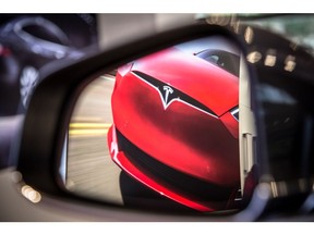 A badge sits on the hood of a Model S electric vehicle displayed inside a Tesla Inc. store in Barcelona, Spain, on Thursday, July 11, 2019. Tesla is poised to increase production at its California car plant and is back in hiring mode, according to an internal email sent days after the company wrapped up a record quarter of deliveries.