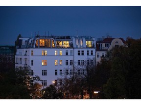 Lights illuminate residential apartments in the Prenzlauer Berg district of Berlin, Germany, on Wednesday, Oct. 23, 2019. Berlin's governing parties struck a deal to freeze rents for five years, marking one of the most radical plans to tackle spiraling housing costs in a major city and hitting the shares of major apartment owners.