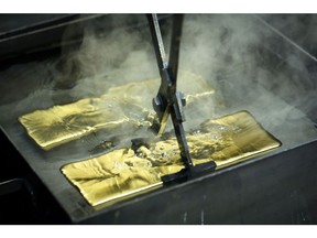 A worker plunges a gold ingot into a cooling bath at the Uralelectromed Copper Refinery, operated by Ural Mining and Metallurgical Co. (UMMC), in Verkhnyaya Pyshma, Russia, on Thursday, July 30, 2020. Gold surged to a fresh record Friday fueled by a weaker dollar and low interest rates. Silver headed for its best month since 1979. Photographer: Andrey Rudakov/Bloomberg