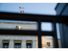 The Marriner S. Eccles Federal Reserve building stands behind a fence in Washington, D.C., U.S., on Tuesday, Aug. 18, 2020. In addition to helping rescue the U.S. economy amid the coronavirus pandemic, Fed Chair Jerome Powell and colleagues also spent 2020 finishing up the central bank's first-ever review of how it pursues the goals of maximum employment and price stability set for it by Congress.