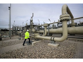 A worker inspects pipework at the Nord Stream 2 gas pipeline landing facility on the Baltic Sea coastline in Lubmin, Germany, on Wednesday, Nov. 5, 2020. Chancellor Angela Merkel's district on the Baltic coast was the site of the last major Soviet military project in communist East Germany and is now at the center of a deepening rift between Cold War allies.