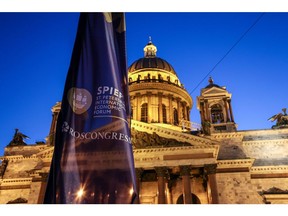 A flag for SPIEF flies outside St. Isaac's cathedral in St. Petersburg.